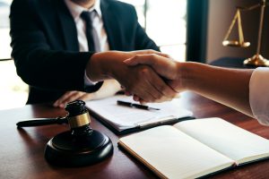 A personal injury solicitor shaking hands with a client.