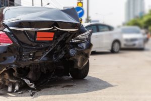 CLOSE UP OF the back of a car following a REAR END CAR COLLISION