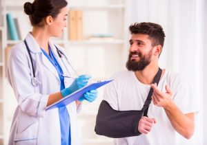 A man getting a medical exam for his broken wrist