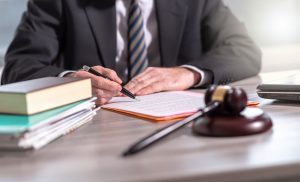 A solicitor sitting at his desk using a road traffic accident compensation calculator for a claim.