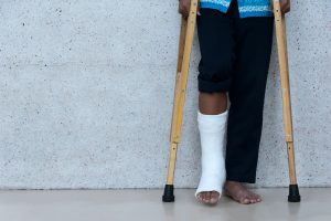 PERSON ON CRUTCHES AFTER SUFFERING A TYPE OF ANKLE INJURY