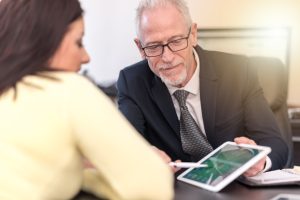 A solicitor shows a client a scar compensation calculator for the UK.