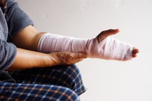 PERSON WITH EXTENSIVE HAND AND ARM BANDAGES AFTER AN ACCIDENT