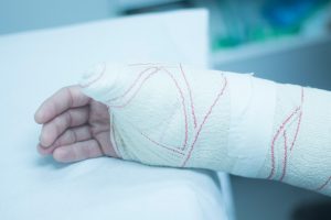 PERSON WITH BANDAGES ON A HAND INJURY